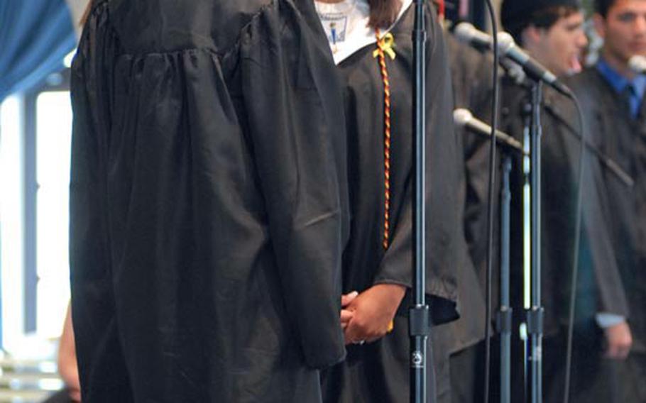 A group of Kaiserslautern High School seniors sing one last time together at the school&#39;s graduation ceremony at the German city&#39;s Fruchthalle building, June 11.