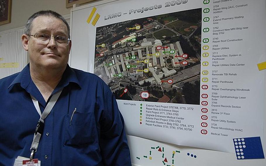 David Reece, Landstuhl Regional Medical Center maintenance branch chief, stands by a list of  projects his staff started or completed in 2009.  The Pentagon wants to build a new hospital closer to Ramstein Air Base.