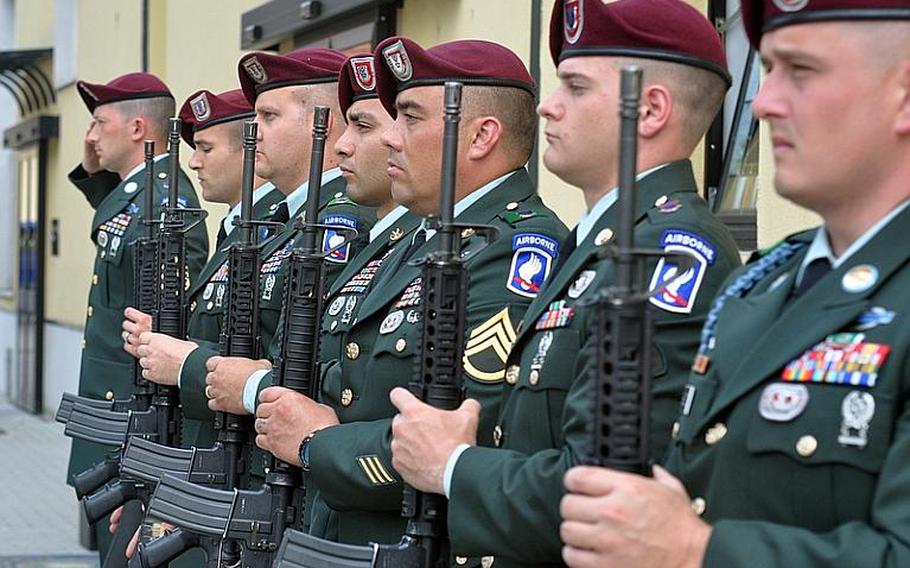 Soldiers with the 173rd Airborne Brigade Combat Team stand at attention in Vicenza, Italy, Tuesday after firing off volleys as a salute to three fellow Sky Soldiers who died in recent weeks in Afghanistan. Mourners were gathered at the nearby Caserma Ederle chapel to remember Spc. Russell E. Madden and Sgts. Matthew R. Hennigan and Louis R. Fastuca.