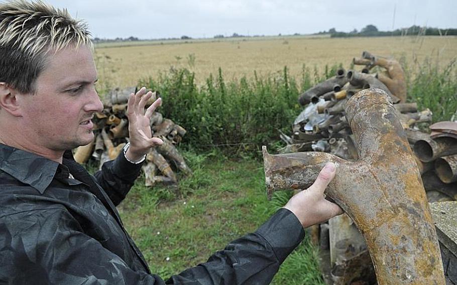 Simon Dunham, a British resident of Norfolk County, England, is an enthusiastic seeker of American World War II-era aircraft parts and
other gear buried in area fields by the Yanks after the war ended in 1945. Holding a piece of a bomber's exhaust system, and with a variety of debris from an excavation last fall around him, Dunham sees a bridge to times past. "Who was the last person who used this? Why was it thrown away?" Dunham asks. "There's a story behind every single part here."