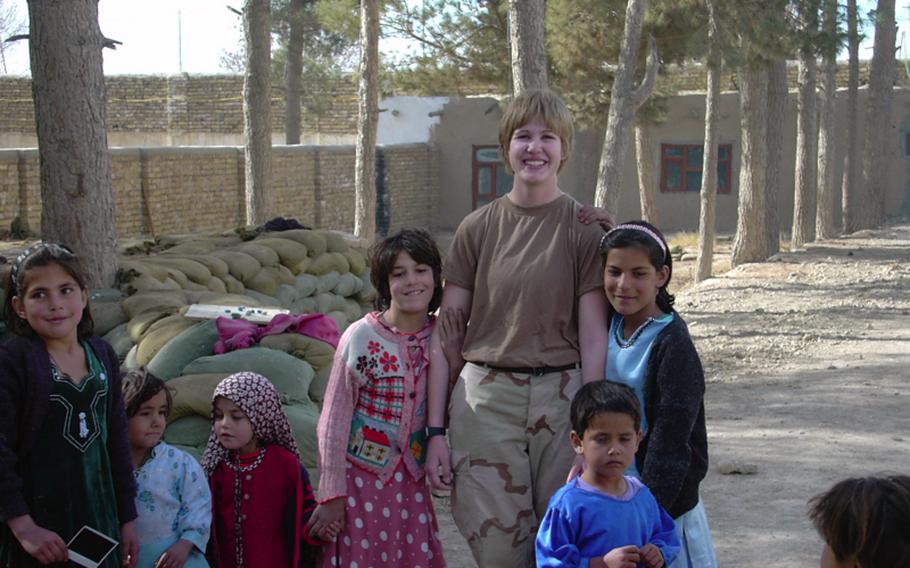 Jennifer Hunt, posing for a photograph with Afghan girls in 2005, was injured in a roadside bomb explosion in 2007 in Iraq. When she visited her local Department of Veterans Affairs hospital to seek treatment for pain, her young female doctor was surprised to learn that Hunt had been injured in combat.