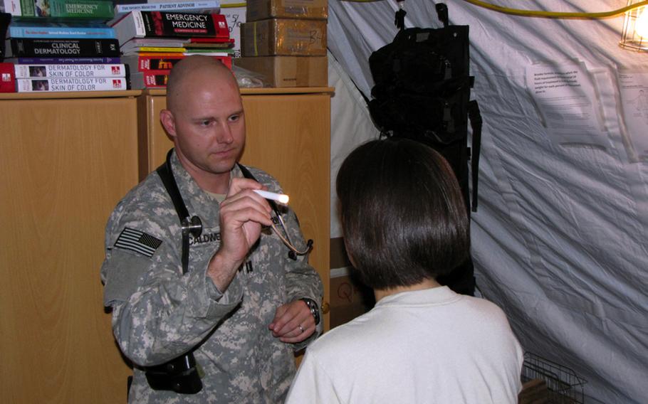 Capt. Aaron Caldwell, 36, of Blacksburg, Va., gives a female airman a checkup at the clinic at Camp Marmal near Mazar-e-Sharif in northern Afghanistan. The Iraq and Afghanistan wars have profoundly changed military service for women, yet on the battlefield and after their tours end, their health care has only recently started to catch up.