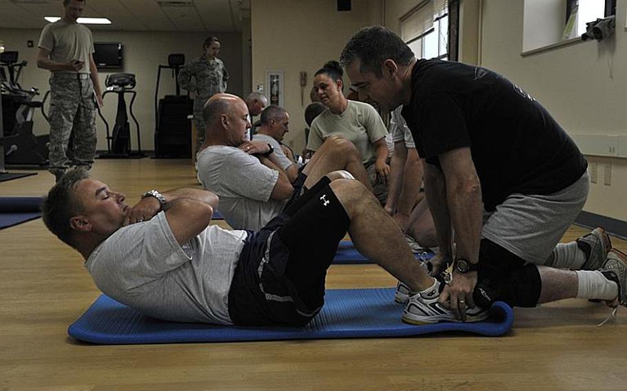 Senior leaders from the Montana Air National Guard perform the sit-up portion of the Air Force fitness test in July. Nearly one-fifth of the 30,000 active duty, reserve and National Guard airmen who took the test failed, Air Force officials said.