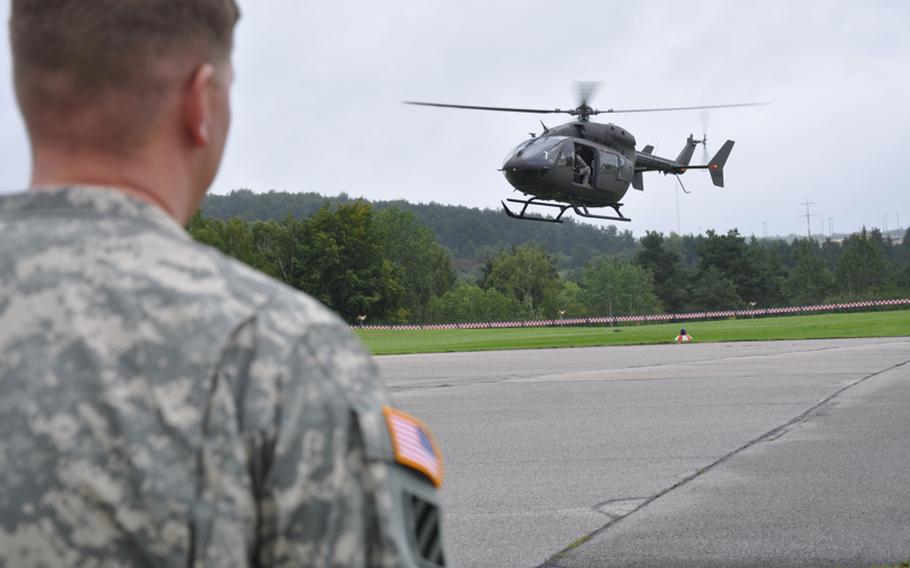 A U.S. soldier watches as a UH-72 Lakota puts on an aerial demonstration Thursday in Hohenfels, Germany. The helicopter is replacing the UH-1 as the Army's light utility helicopter.