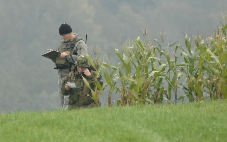 U.S. Air Force Tech. Sgt. Matthew Muse, left, listens as Maj. Andreas Olssen of the Norwegian army calls in an airstrike during field training at the joint terminal attack controller course near Bann, Germany, on Sept. 28. Muse is an instructor with the U.S. Air Forces in Europe&#39;s Air Ground Operations School.