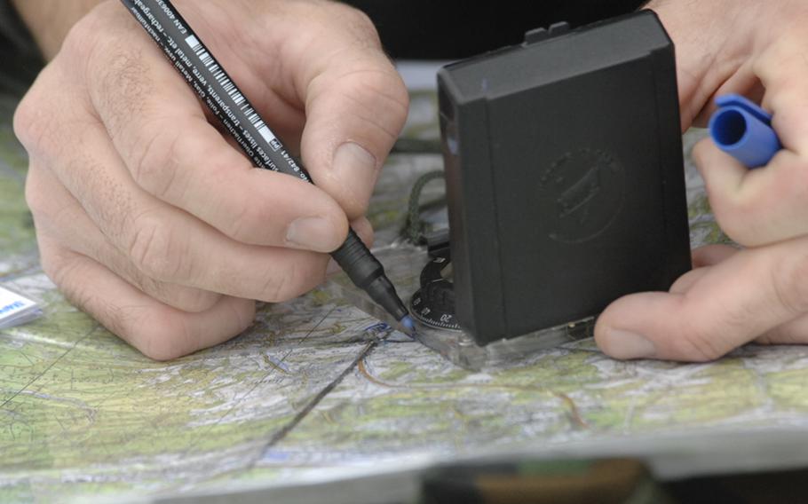 A student in the  U.S. Air Forces in Europe Air Ground Operation School&#39;s joint terminal attack controller course plots the coordinates for an airstrike during field training near Bann, Germany, on Sept. 28.