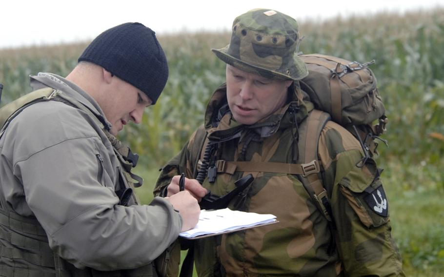 U.S. Air Force Tech. Sgt. Matthew Muse, left, and Maj. Andreas Olssen of the Norwegian army review Olssen&#39;s turn at calling in an airstrike during field training at the joint terminal attack controller course near Bann, Germany, on Sept. 28. Muse is an instructor with the U.S. Air Forces in Europe&#39;s Air Ground Operations School.
