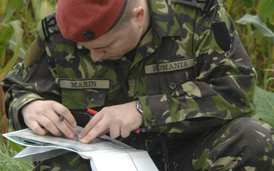 Romanian 1st Lt. Daniel Marin plots target coordinates before he calls in an airstrike during field training at the joint terminal attack controller course near Bann, Germany, on Sept. 28.