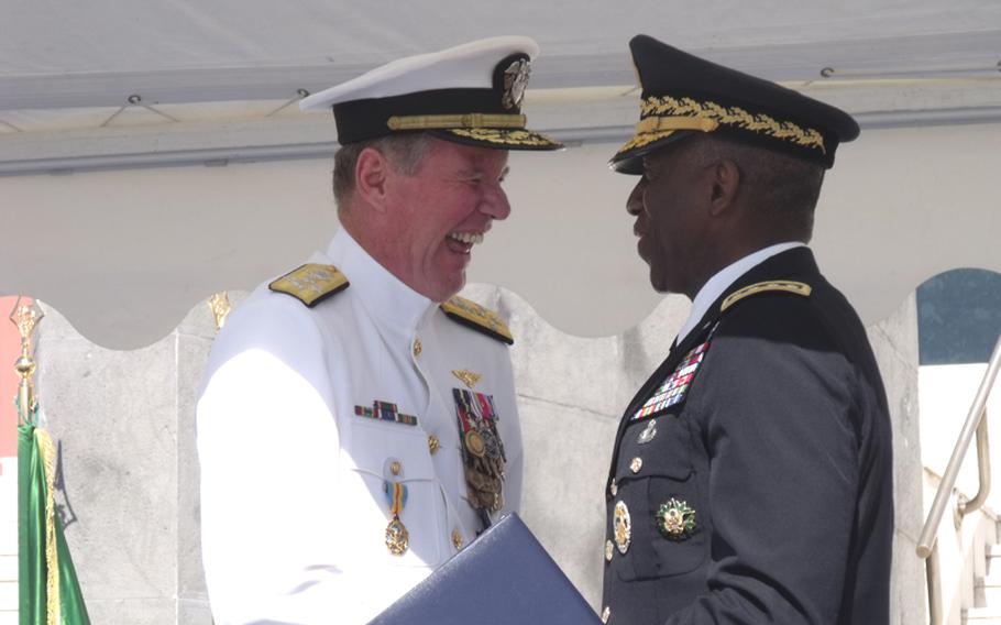 Gen. William Ward, AFRICOM commander, right, congratulates Adm. Mark Fitzgerald on his retirement from the Navy at a change of command ceremony in Naples on Wednesday.