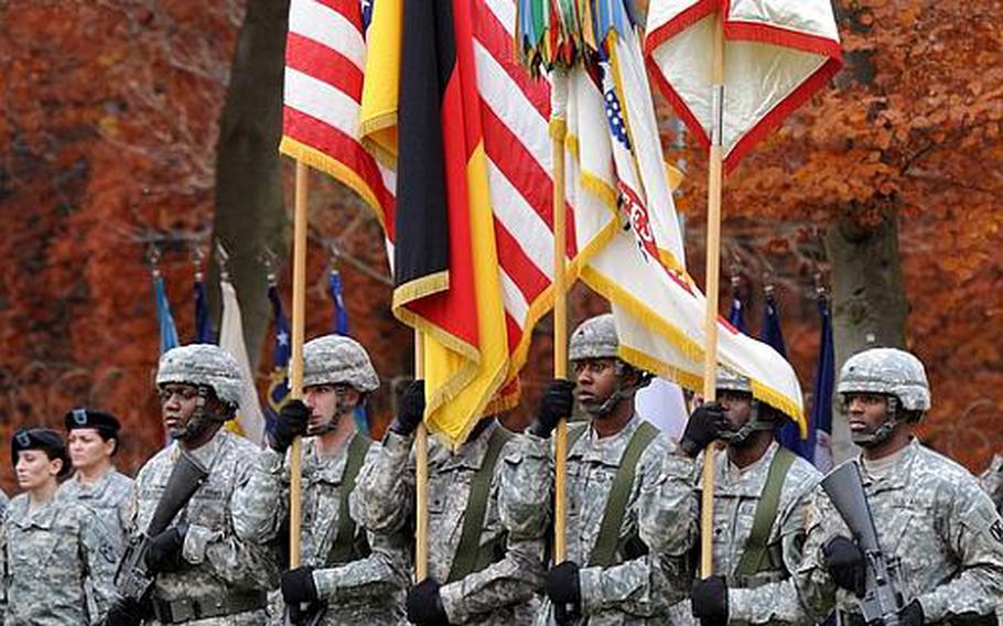 The 21st Theater Sustainment Command color guard marches onto the Panzer Kaserne parade ground at the fallen soldier retreat in Kaiserslautern, Germany, on Thursday afternoon. The names  of Staff Sgts. James Ide and Derek Farley and Sgt. Anton Phillips were added to the 21st TSC memorial at the ceremony, where Sgt. Maj. of the Army Kenneth Preston was guest speaker.