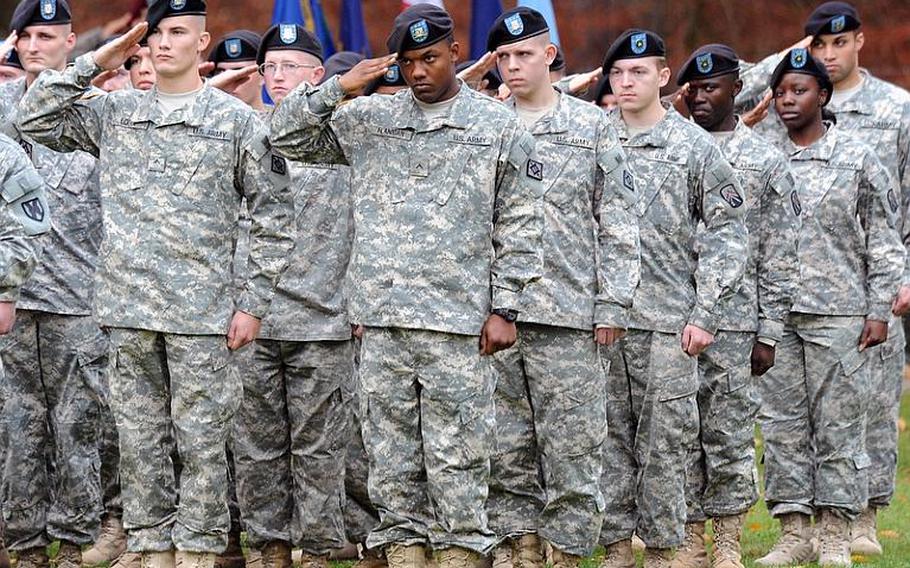 Soldiers from the 21st Theater Sustainment Command salute during the rendering of honors at the fallen soldier retreat on Panzer Kaserne in Kaiserslautern, Germany, on Thursday afternoon. Sgt. Maj. of the Army Kenneth Preston was guest speaker at the ceremony where three names were added to the 21st TSC memorial.