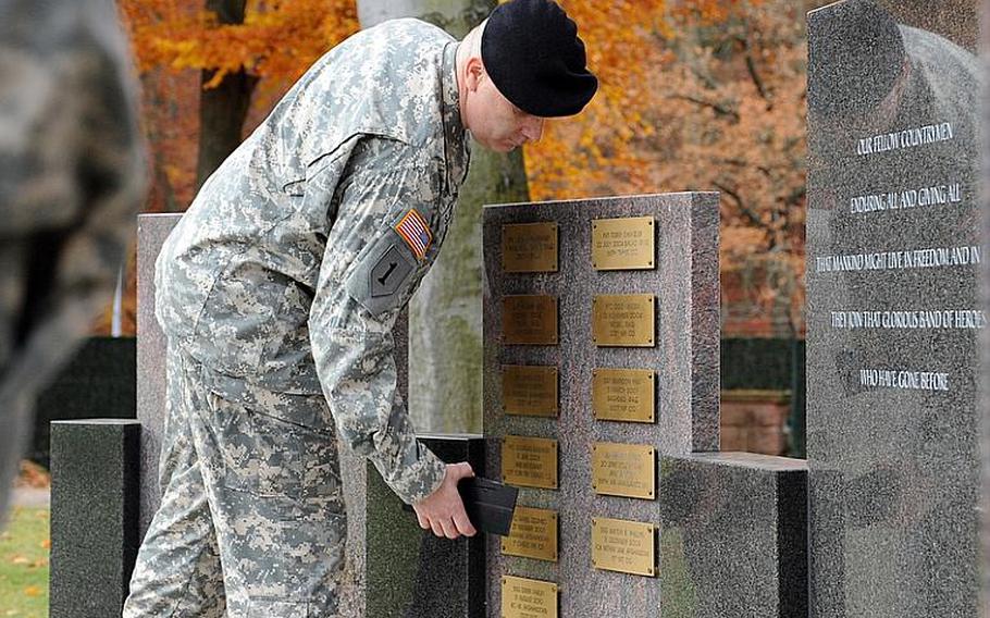 Col. Keith Sledd, 16th Sustainment Brigade commander, unveils the plaques of Sgt. Anton Phillips and Staff Sgt. Derek Farley on the 21st Sustainment Command's fallen soldier memorial at Panzer Kaserne in Kaiserslautern, Germany, on Thursday afternoon. During the ceremony a plaque for Staff Sgt. James Ide was also unveiled by the 18th Military Police Brigade commander, Col. Thomas Evans. The retreat honoring the fallen soldiers was hosted by the 21st Sustainment Command under Brig. Gen. Patricia McQuistion, and the guest speaker was Sgt. Maj. of the Army Kenneth Preston.

Michael Abrams/Stars and Stripes