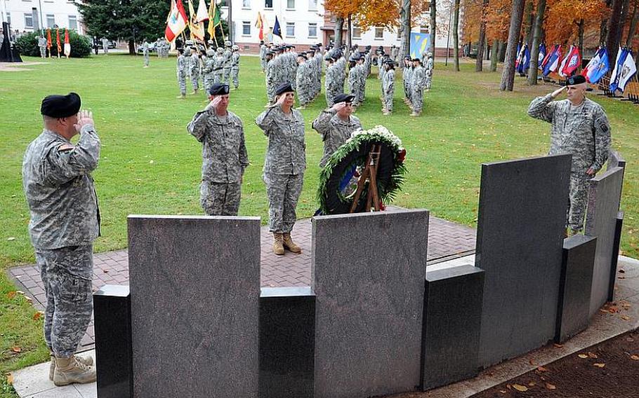 Col. Thomas Evans, Sgt. Maj. of the Army Kenneth Preston, Maj. Gen. Patricia E. McQuistion, Command Sgt. Maj. James E. Spencer and Col. Keith Sledd, from left, salute during the playing of taps at the 21st Sustainment Command's fallen soldier memorial at Panzer Kaserne in Kaiserslautern, Germany, on Thursday afternoon. Sledd, the 16th Sustainment Brigade commander, unveiled plaques for Sgt. Anton Phillips and Staff Sgt. Derek Farley on the 21st TSC's memorial. Evans, commander of the 18th Military Police Brigade, unveiled one for Staff Sgt. James Ide.
