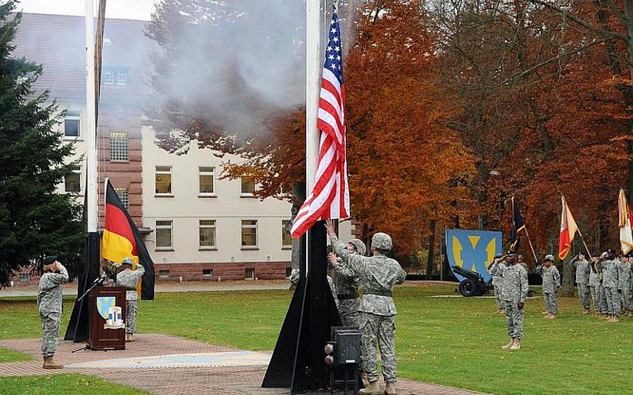 Maj. Gen. Patricia McQuistion, commander of the 21st Theater Sustainment Command, left, salutes as the American and German flags are lowered at the 21st TSC's fallen soldier retreat at Panzer Kaserne in Kaiserslautern, Germany, on Thursday.