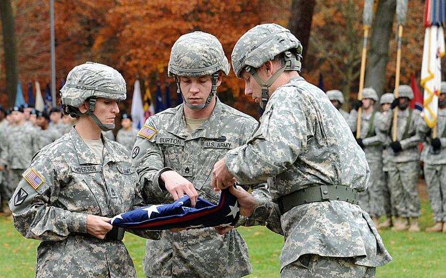 Soldiers of the 21st Theater Sustainment Command fold the American flag at the command's fallen soldier retreat at Panzer Kaserne in Kaiserslautern, Germany, on Thursday.