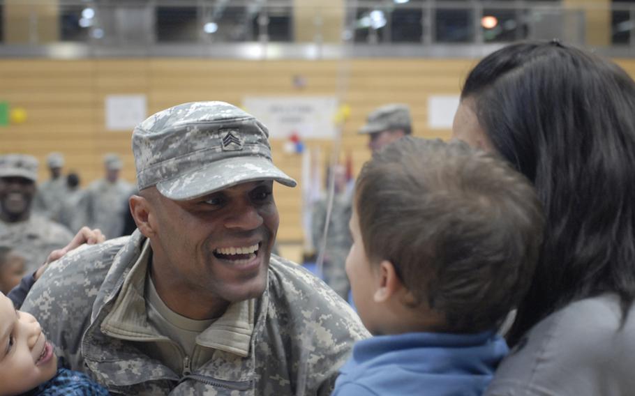 Sgt. Alexander Mason, 146th Signal Company, smiles at his son Isaiah, 2,  at Tuesday's welcome home celebration for the 1st Armored Division's advance party in Wiesbaden, Germany.  Ninety-six soldiers returned from a yearlong deployment to Iraq.'