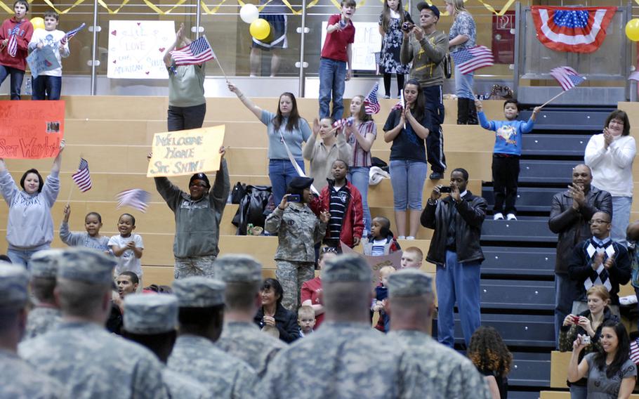 Family and friends cheer the arrival of the 1st Armored Division advance party at the Wiesbaden Fitness Center Tuesday night.  Ninety-six soldiers returned from Iraq to Wiesbaden, Germany, Tuesday night.