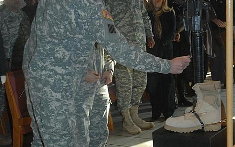 Joint Multinational Training Command chief Brig. Gen. Steven Salazar pays his last respects at a memorial Wednesday for Pfc. Conrado Diaz Javier Jr. at Vilseck, Germany. Javier died Dec. 19 from injuries received from a roadside bomb in Afghanistan.

Seth Robson/Stars and Stripes