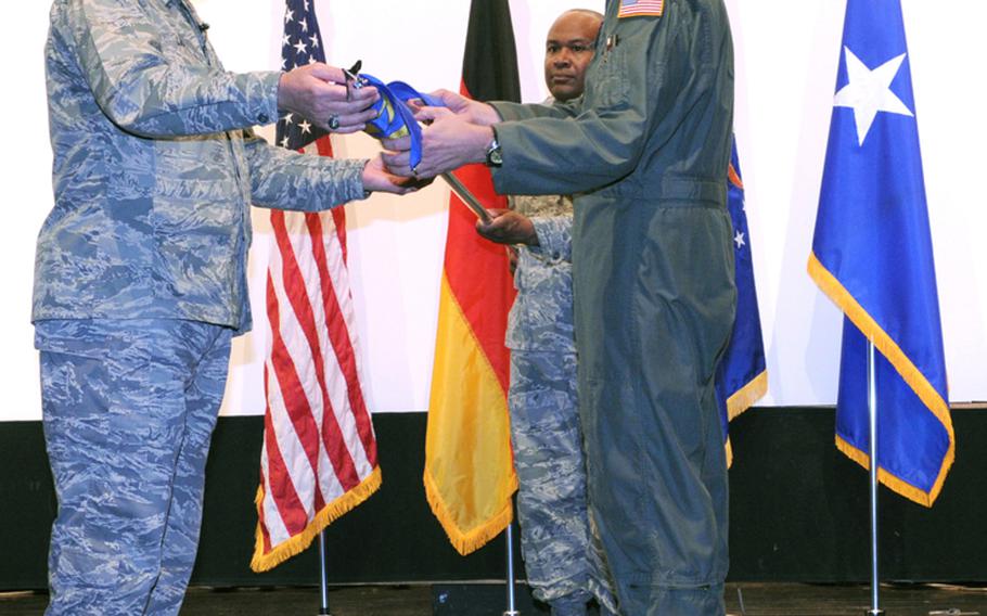 Former 17th Air Force commander Maj. Gen. Ron Ladnier, left, and Col. Andy Redmond, then incoming commander of the 617th Air and Space Operations Center, unfurl the 617th flag at an activation ceremony in May 2009. The Ramstein-based 617th and the 603rd Air and Space Operations centers will merge to meet Pentagon cost-cutting measures announced this week.