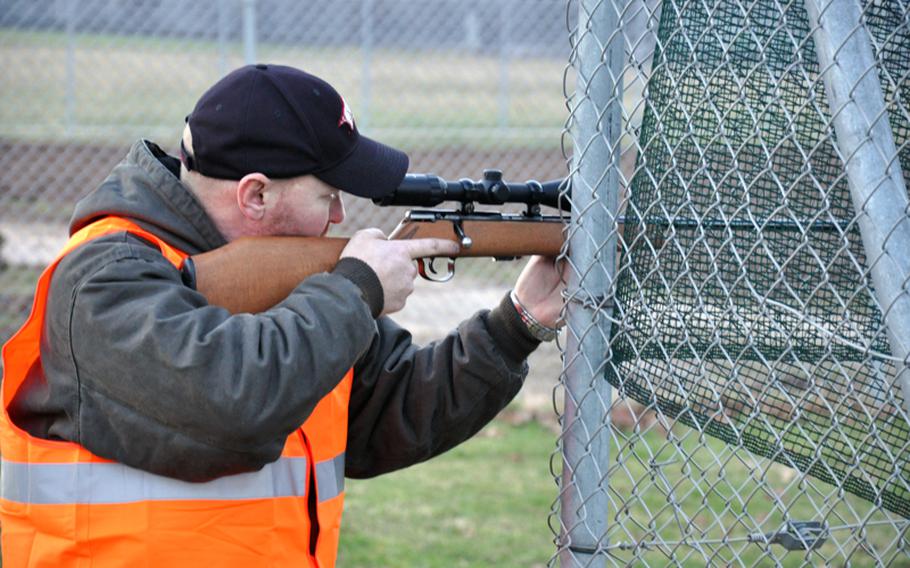 Chris Wachtendorf, a native of Russellville, Ark., takes aim at a rabbit on Heidelberg, Germany's Patrick Henry Village on Monday. An estimated 1,000 to 2,000 rabbits have invaded the base causing damage to property.