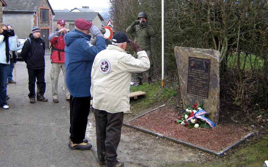 Two 82nd Airborne Division veterans, Dick Fields, left, and Ray Fary, take part in a wreath-laying ceremony during last year's walk at a monument to the 504th Parachute Infantry Regiment in Cheneux, Belgian.