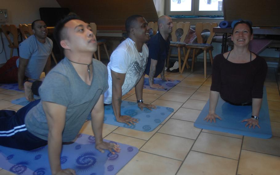 From left: Staff Sgt. Lincoln Manning, in background, 30, of New York; Sgt. Mark Coloma, 28, of Honolulu; Sgt. 1st Class Milton Johnson, 36, of Chicago and Staff Sgt. Neil Kessler, 32, of Albany, N.Y., learn yoga with the help of instructor Sarah Brown near Grafenwoehr, Germany, on Wednesday.