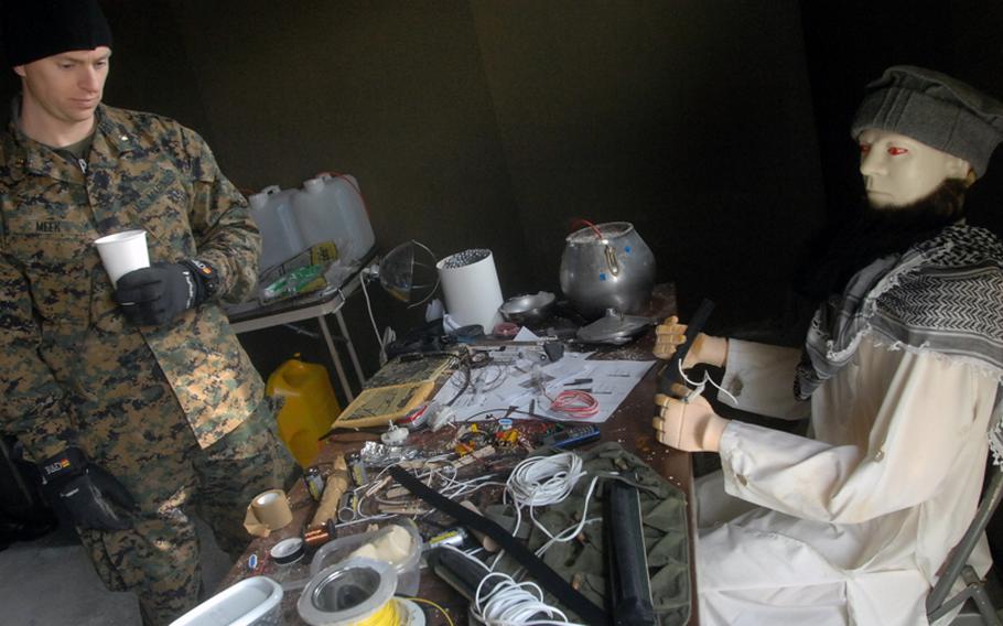 U.S. Marine Maj. Don Meek, 34, of Tuftonboro, N.H., checks out a mock-up of a bomb-maker&#39;s lair at Hohenfels last Thursday.