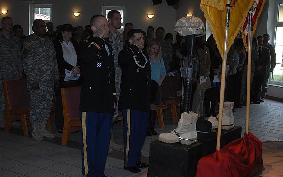 The 2nd Stryker Cavalry Regiment Rear Detachment commander, Lt. Col. David McCulley, left, and Sgt. Maj. James Rogers pay tribute to Pfc. Andrew M. Harper and Pfc. Kalin C. Johnson at Rose Barracks Cavalry Chapel in Vilseck, Germany, on Thursday.