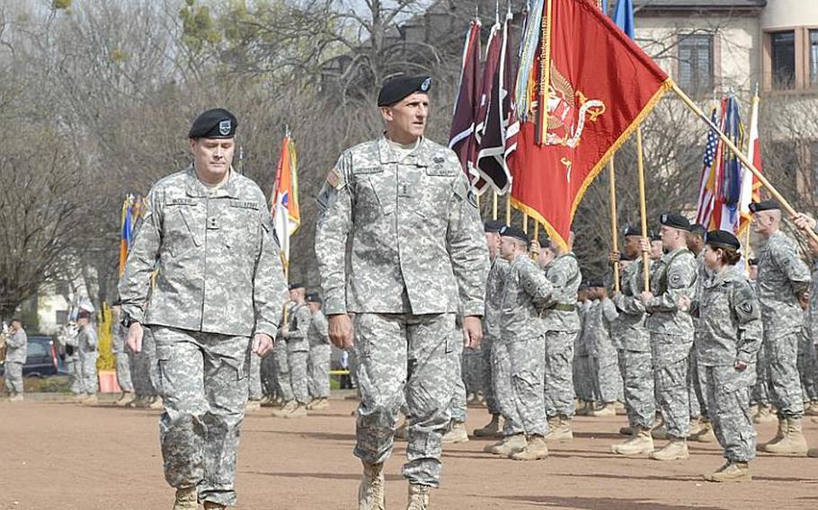 U.S. Army Europe's deputy commander, Maj. Gen. Terry A. Wolff, left, and Lt. Gen. Mark P. Hertling, the new USAREUR commander, inspect troops Friday at Heidelberg's Campbell Barracks prior to Hertling assuming command of USAREUR.