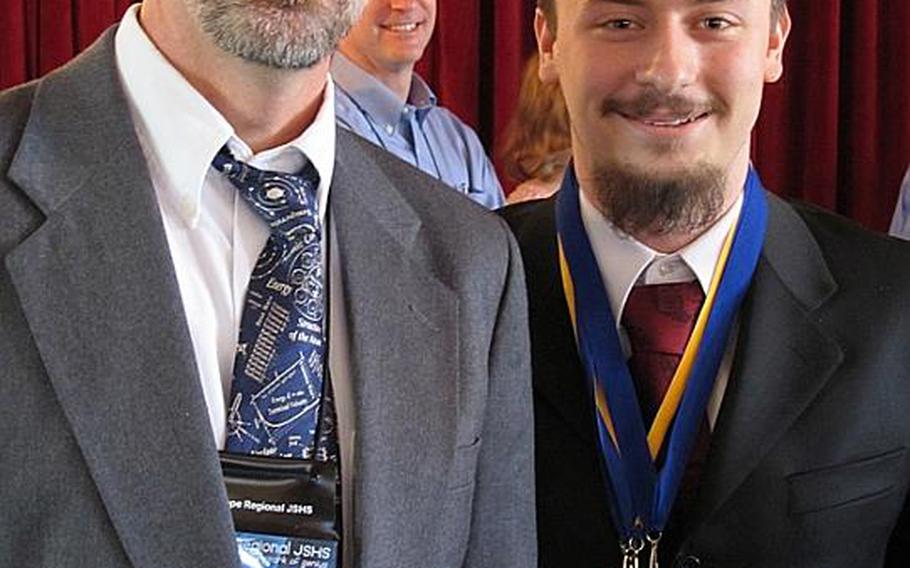 Kevin Burdge, right, first-place oral presentation winner at the 37th Annual Junior Science and Humanities Symposium, poses with  Ray Smola, a Heidelberg High School teacher, after winning his award. Burdge will represent the Department of Defense Dependents Schools-Europe at the national JSHS symposium in San Diego this month.