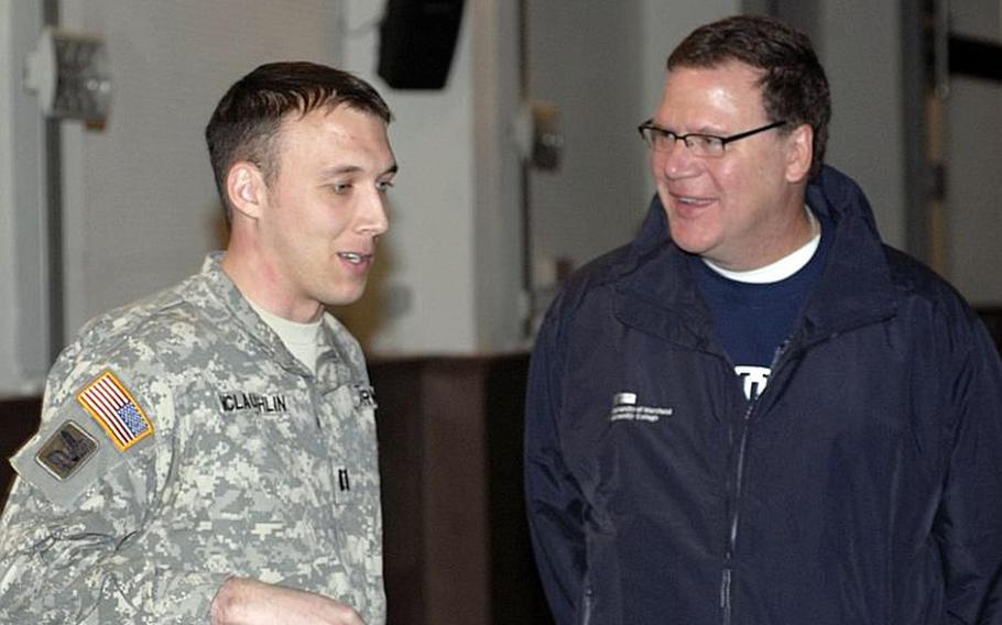 Capt. Matthew McLaughlin, left, 457th Civil Affairs Battalion, speaks with Paul Harris during a Salute to Education event on March 17 at Wiesbaden Army Airfield. Harris is associate director of the Auburn University Honors College in Alabama and was the featured speaker.
