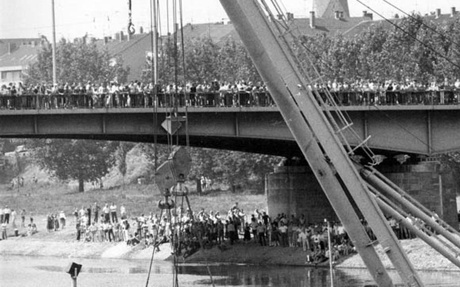 A German "Floating Achilles" crane lifts a 50-ton M-60 tank out of the Neckar River at Mannheim, Germany, in July, 1982. The tank had been stolen by a U.S. soldier and driven on a rampage through Mannheim, demolishing a streetcar and several cars and injuring three people. It was then trapped on the bridge, but in backing off the driver went over the edge and was killed.