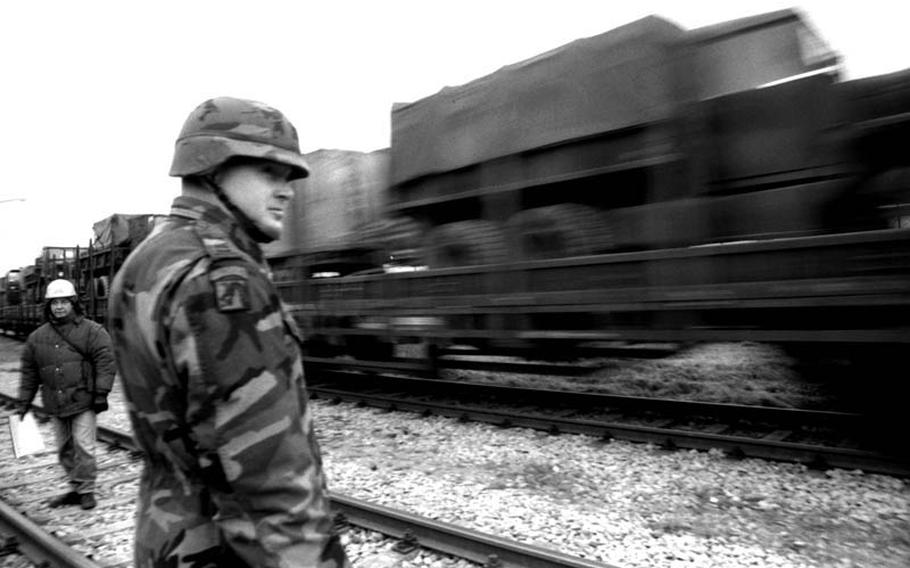 In December, 1995: Capt. Steve Durham watches as the first train loaded with military equipment leaves the Coleman Barracks railhead on its way to Zagreb, Croatia, to help pave the way for the NATO peacekeeping force in the Balkans. Durham is in charge of the 15-person Movement Control Team at Mannheim, which works as a point of contact between the U.S. Army and the German rail system.