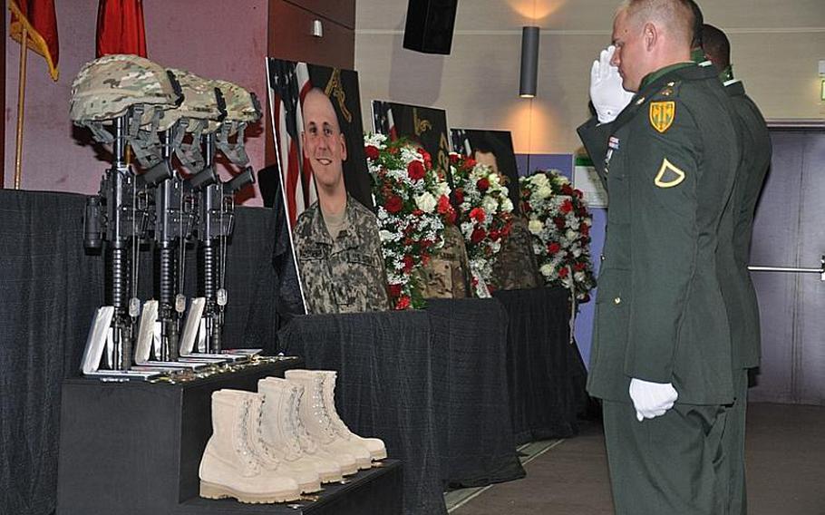 Soldiers render a salute Wednesday in Hohenfels, Germany, at a memorial service for Staff Sgt. Joshua A. Throckmorton, 28, of Battle Creek, Mich.; Spc. Jordan C. Schumann, 24, of Port St. Lucie, Fla. and Spc. Preston J. Suter, 22, of Sandy, Utah.