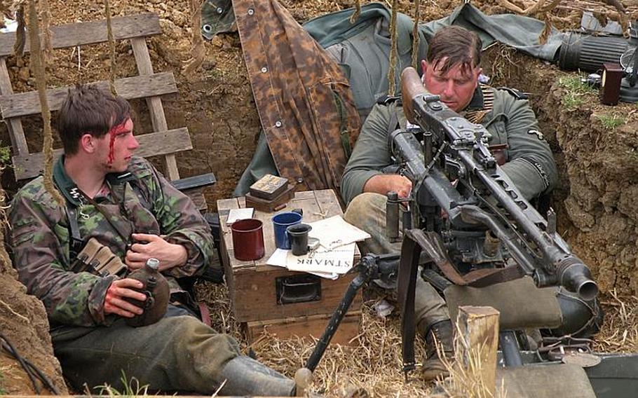 German soldier re-enactors sit in a machine-gun nest in full fatigues during the War and Peace show. Next year, the event will take place  July 18-22.
