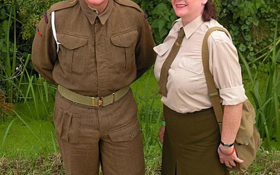 A couple dressed in the traditional World War II British "Tommy" uniforms at the War and Peace show. Re-enactors and many event goers dressed in uniforms mainly from the British, U.S., German and Australian militaries, as well as other countries.  
