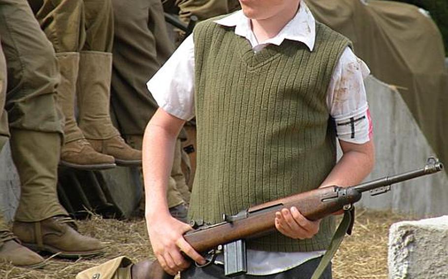 Even the kids get involved at the War and Peace show. Here a young boy re-enactor patrols a mock base.
