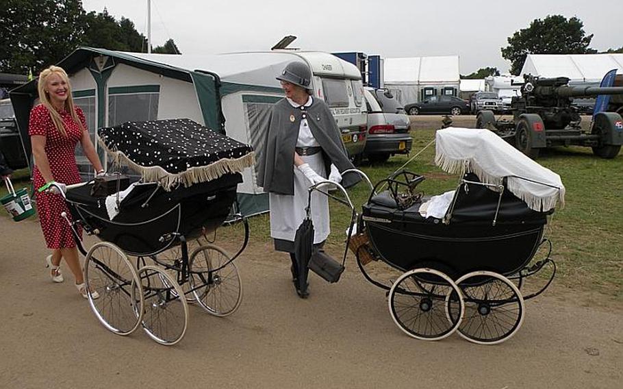 Two ladies in costume push lavish prams at the War and Peace show a few miles south of London.
