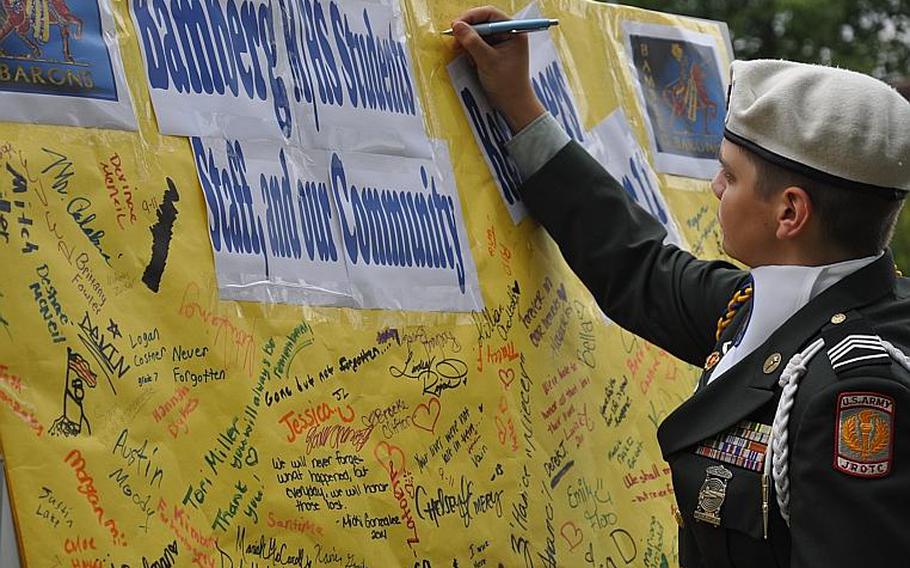 Cadet Staff Sgt. Daniel Riojas, a senior at Bamberg Middle/High Schoo, leaves a remembrance message prior to a 9-11 ceremony Friday at the school.