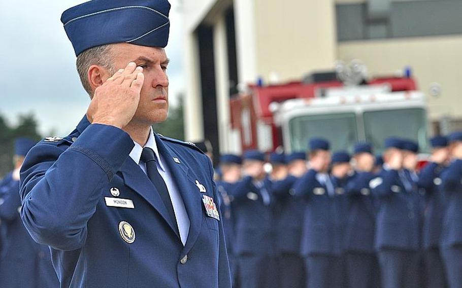 Col. Michael Monson, commander of the 86th Mission Support Squadron, salutes during the playing of the "Star-Spangled Banner" at a ceremony Friday at Ramstein Air Base commemorating the 10th anniversary of the attacks on Sept. 11.