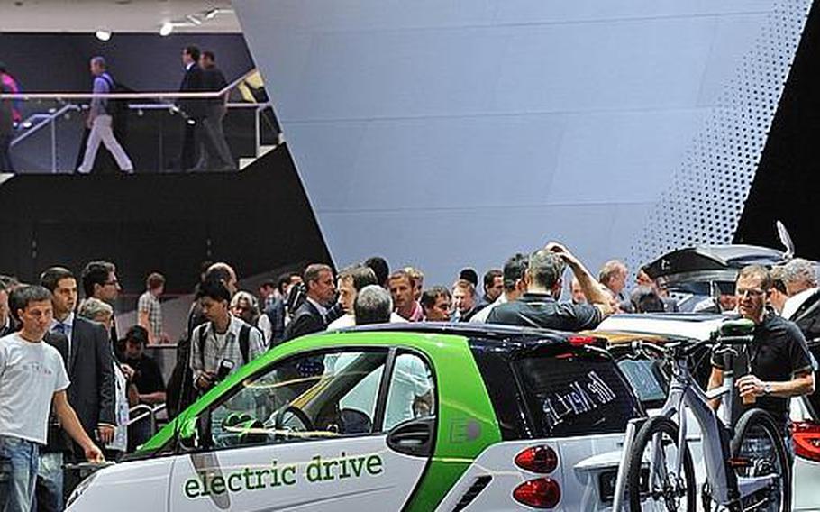 Mercedes celebrated 125 years of car-making at the Frankfurt International Auto Show, unveiling the SLS AMG Roadster, seen at top. In the foreground their subsidiary, smart, showed the third generation of its smart &#39;fortwo&#39; electric drive car, seen at bottom carrying a smart ebike.