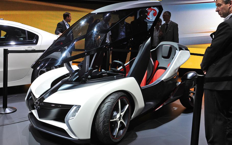 The Opel RAK e concept car is a two-seater, with a single passenger sitting behind the driver, like on a motorcycle. It was one of many small, energy-efficient two-seaters presented by auto makers at the Frankfurt International Motor Show.