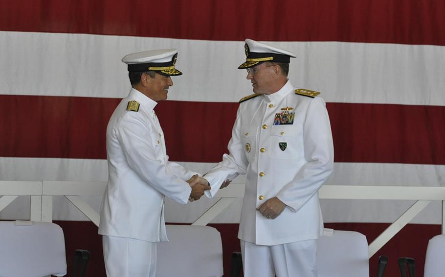 New Navy 6th Fleet commander Vice Adm. Frank C. Pandolfe, right, shakes hands with outgoing commander Vice Adm. Harry B. Harris, Jr. on Monday during a change of command ceremony in Naples, Italy.