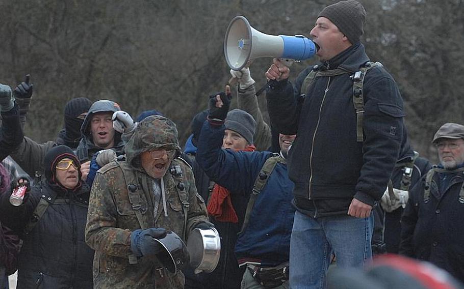 Men and women play the role of protesters during a Nov. 17 civil disturbance training exercise at the Joint Multinational Readiness Center in Hohenfels, Germany. The exercise was part of the training for U.S. and multinational soldiers bound for Kosovo as peacekeepers.