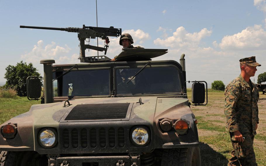 Marines from Scout Platoon, Headquarters and Service Company, 1st Tank Battalion, train soldiers from the Macedonian Army&#39;s Scorpion Company, 1st Battalion, 1st Brigade in convoy operations at Babadag training area, Romania, June 10, 2010. The peacekeeping training the Macedonian soldiers received was designed to prepare them for an upcoming deployment to Afghanistan. Some critics of the large U.S. military footprint in Europe say rotational forces could be  more efficient way to conduct training in Europe.