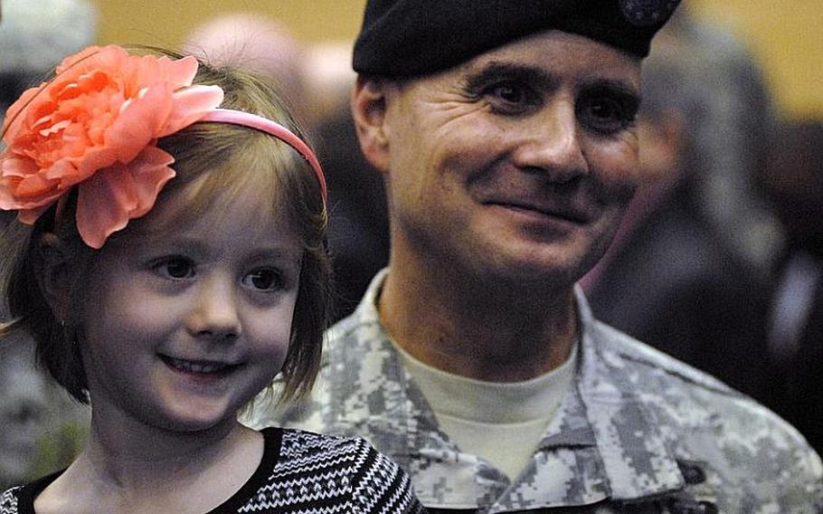 Col. David Carstens greets guests with his daughter, Nina, on Jan. 12, 2012, the day he assumed command of Wiesbaden Army Airfield.