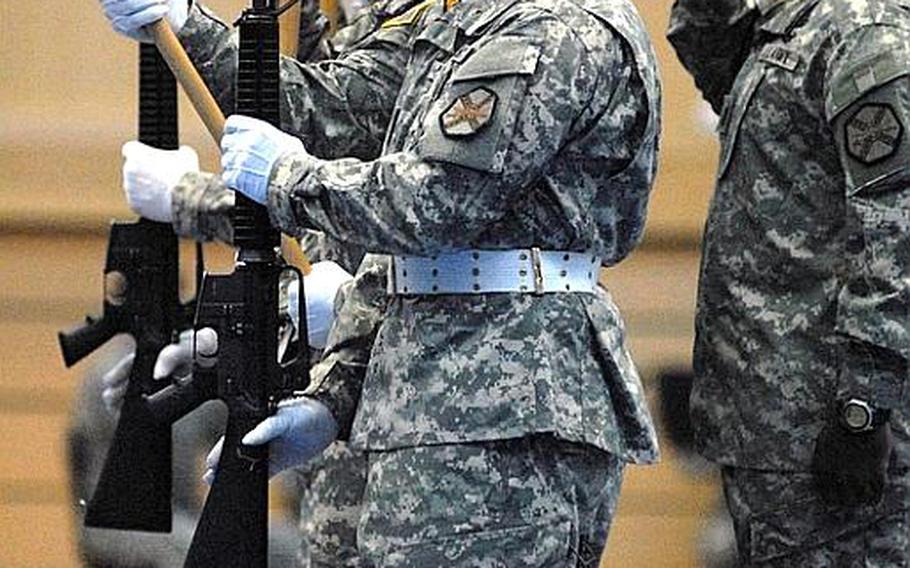 The color guard stands at attention as the garrison's command sergeant major, Command Sgt. Maj. Hector Prince, salutes during a change-of-command ceremony Jan. 12, 2012, at Wiesbaden Army Airfield in Germany.  Col. David Carstens took the reins of U.S. Army Garrison Wiesbaden from outgoing commander Col. Jeffrey Dill.