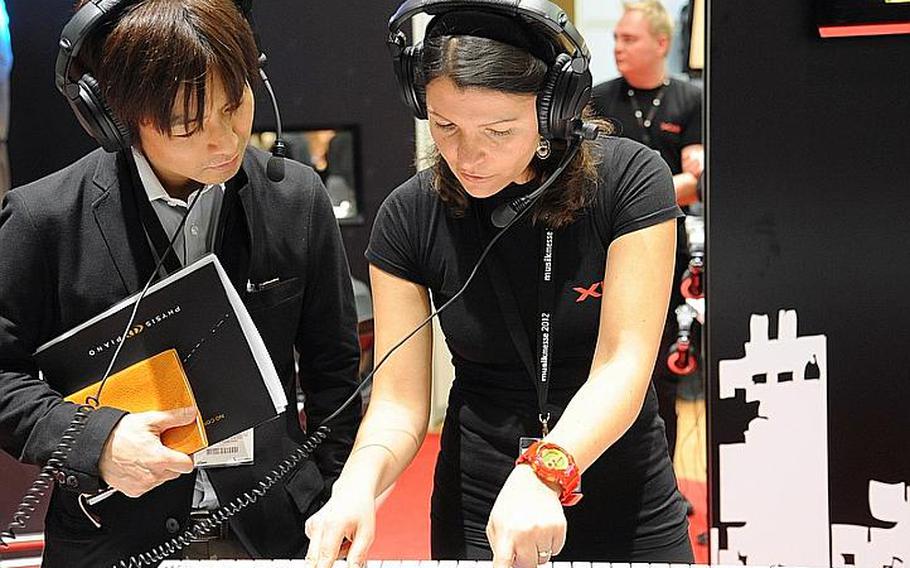 A member of the Casio staff demonstrates the features of an electronic keyboard during the Musikmesse international music fair in Frankfurt, Germany, on March 21, 2012. About 1,500 exhibitors are spotlighting their wares at the fair, which opens its doors to the general public March 24, 2012, at the city's fairgrounds (Messe).