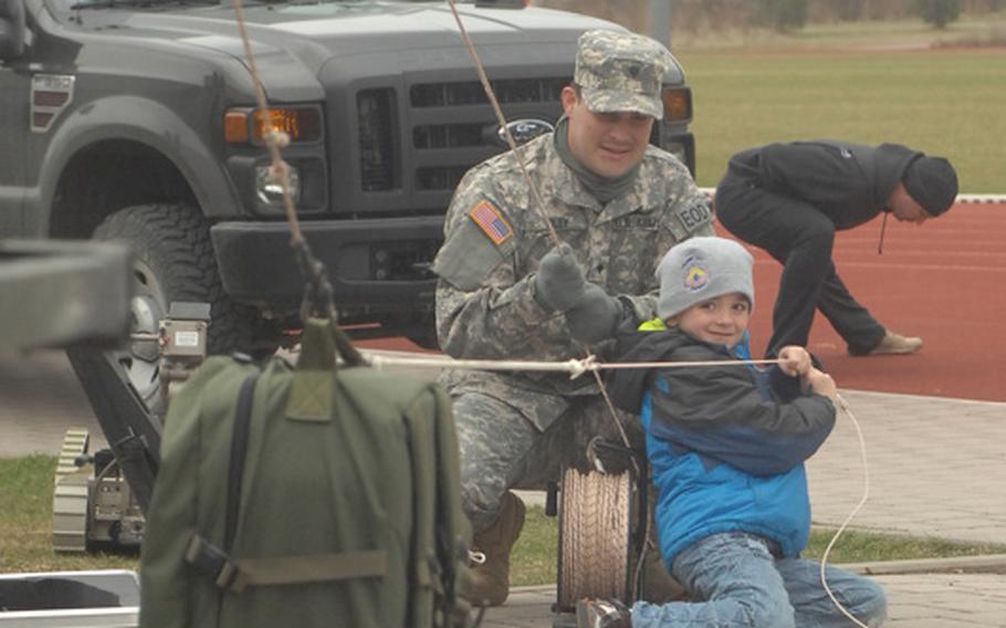 Noah Lopez, 7, plays with a rope and pulley during a March 31, 2012, event sponsored by the 702nd EOD in Grafenwoehr, Germany. Two soldiers in the unit apparently set new world records for a one-mile run in a bomb suit as part of the event. They are waiting for the results to be certified.