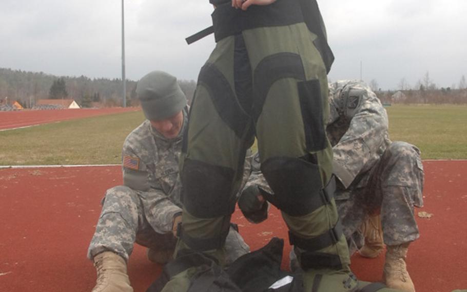 Army Sgt. Stephanie Beachley of the 702nd EOD suits up for her attempt to set a world record for women for a one-mile run in a bomb suit on March 31, 2012, in Grafenwoehr, Germany. Beachley would finish with a time of 13 minutes, 14 seconds, which she expects to be recognized by the Guinness Book of World Records.